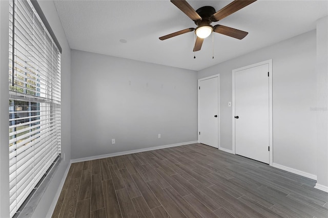 unfurnished bedroom featuring dark hardwood / wood-style flooring and ceiling fan