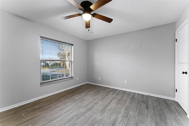 spare room featuring hardwood / wood-style flooring and ceiling fan