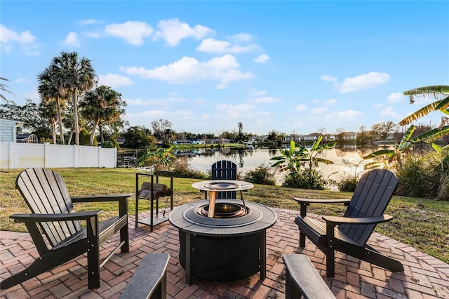 view of patio featuring a water view and an outdoor fire pit