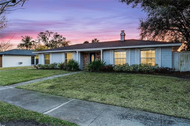 single story home featuring a yard