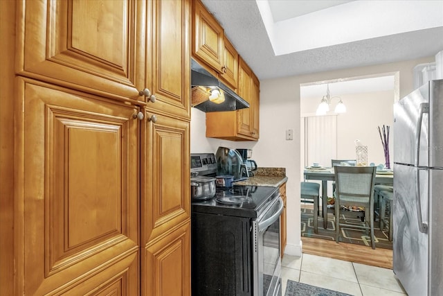 kitchen featuring a notable chandelier, decorative light fixtures, light tile patterned floors, stone counters, and stainless steel appliances