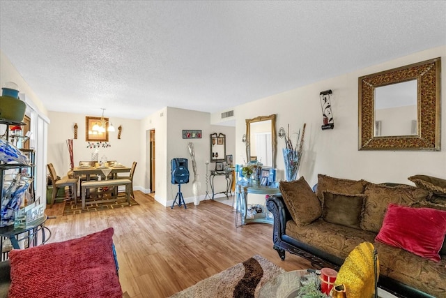 living room featuring wood-type flooring and a textured ceiling