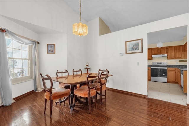 dining area with hardwood / wood-style flooring and lofted ceiling