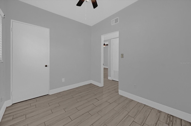 empty room with light hardwood / wood-style flooring and ceiling fan