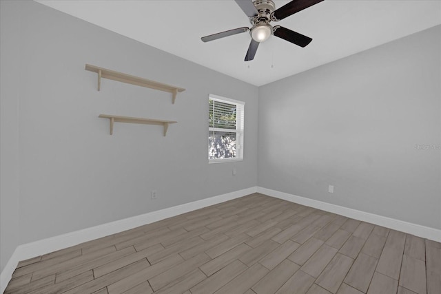 empty room with ceiling fan and light hardwood / wood-style floors