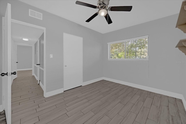 unfurnished room featuring ceiling fan and light wood-type flooring