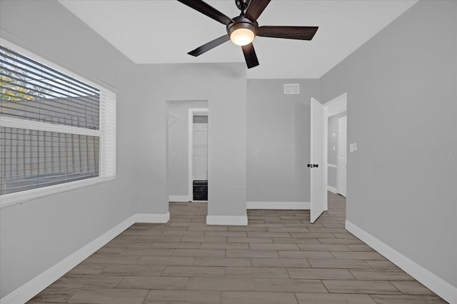 unfurnished room with ceiling fan