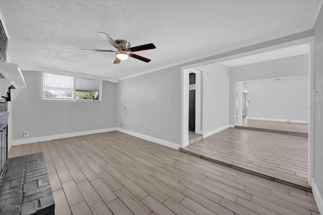 interior space featuring ceiling fan, a textured ceiling, and light hardwood / wood-style flooring