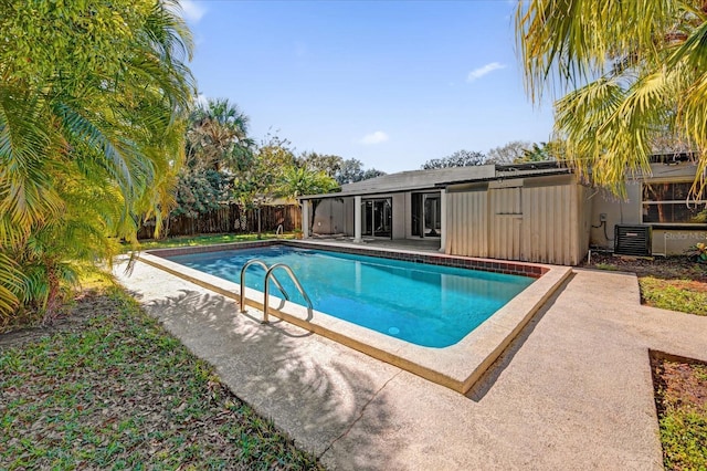 view of swimming pool with central AC unit