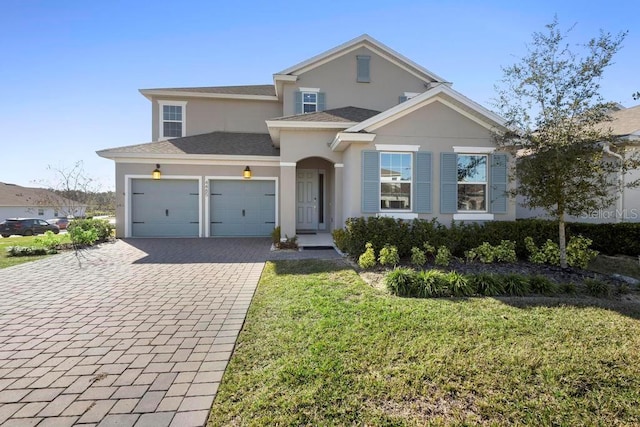 view of front of property featuring a garage and a front yard