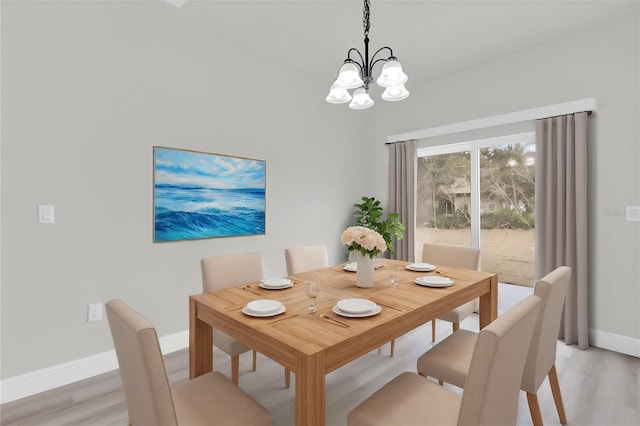 dining area featuring an inviting chandelier and light wood-type flooring