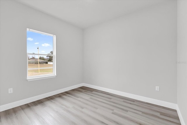 empty room with light hardwood / wood-style flooring