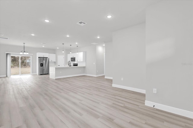 unfurnished living room featuring light hardwood / wood-style flooring