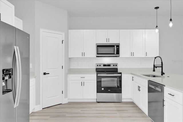 kitchen featuring white cabinetry, sink, and appliances with stainless steel finishes