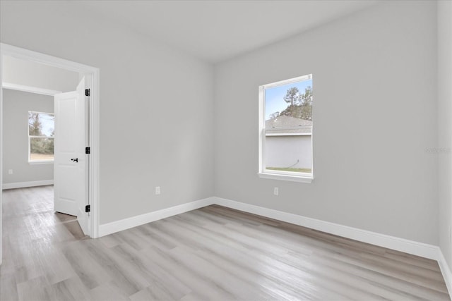 spare room featuring light hardwood / wood-style floors and a wealth of natural light