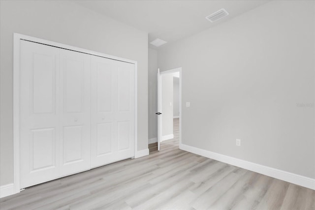 unfurnished bedroom with light hardwood / wood-style floors and a closet