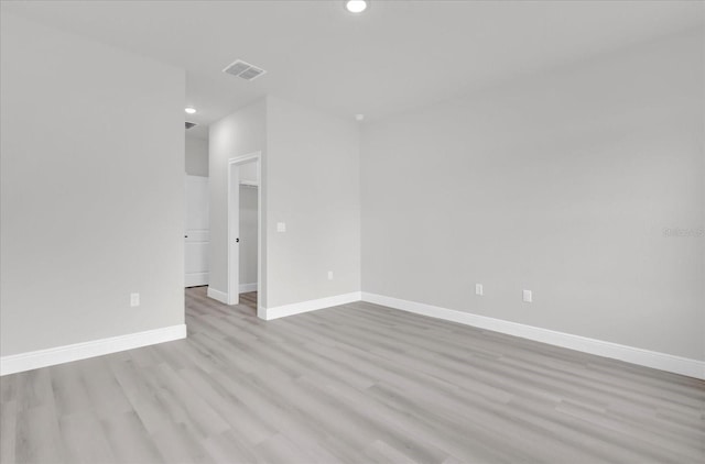 spare room featuring light hardwood / wood-style flooring