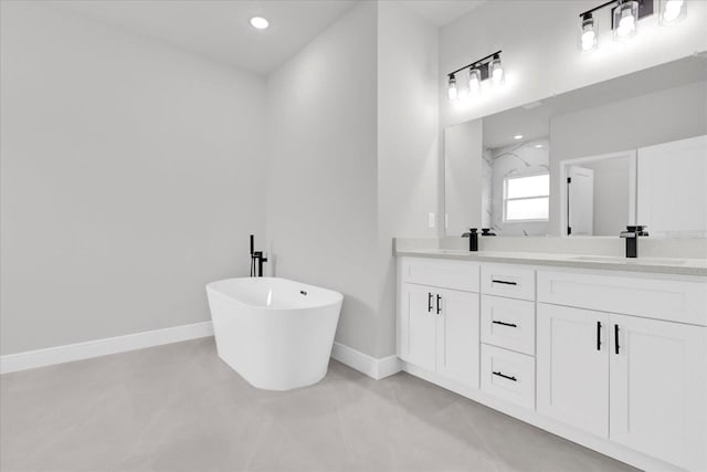 bathroom with concrete flooring, vanity, and a bath