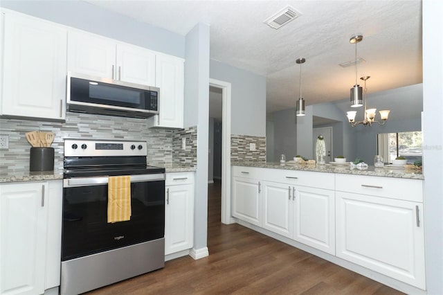 kitchen featuring appliances with stainless steel finishes, backsplash, white cabinets, dark hardwood / wood-style flooring, and decorative light fixtures