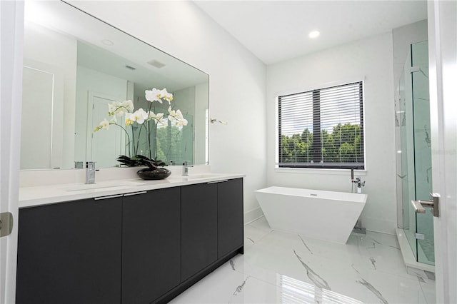 bathroom with vanity and independent shower and bath