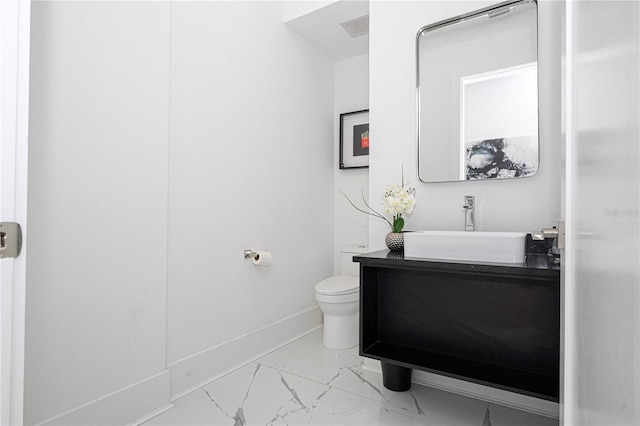 bathroom featuring vanity and toilet