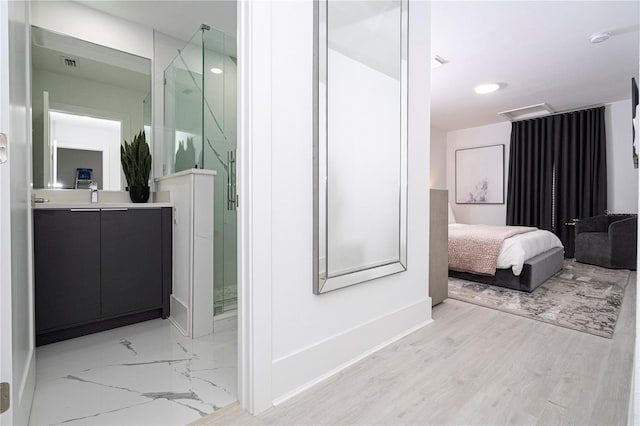 bathroom featuring vanity and a shower with shower door