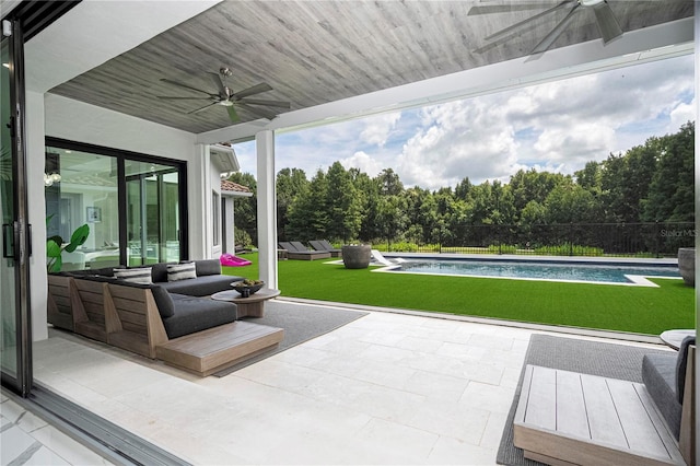 view of patio with ceiling fan and a fenced in pool