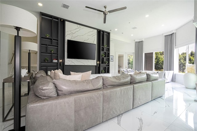 living room featuring built in shelves and ceiling fan