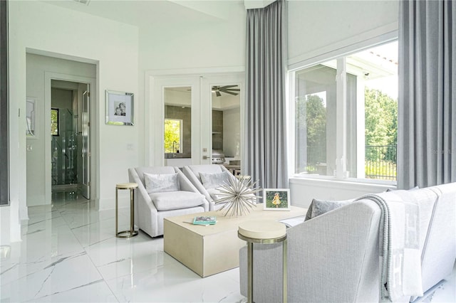 sunroom / solarium with ceiling fan and plenty of natural light