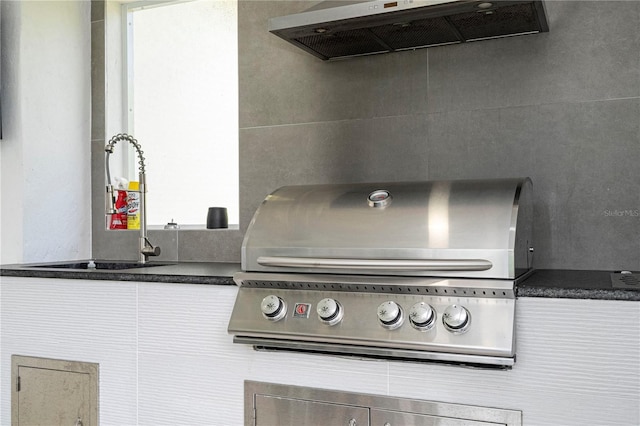 interior space with range hood and sink