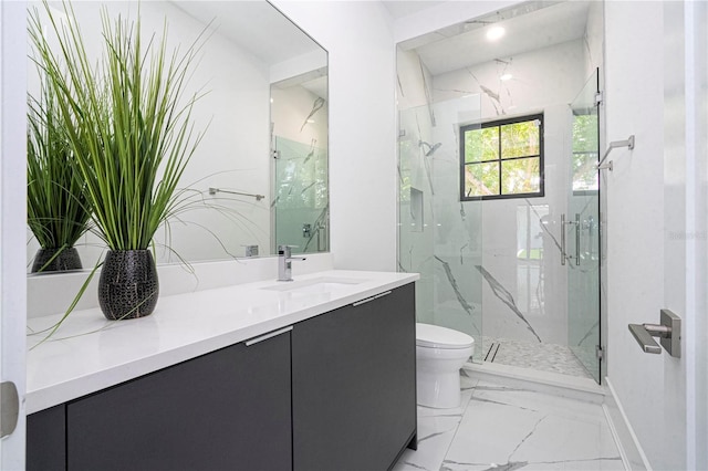 bathroom featuring vanity, toilet, and an enclosed shower