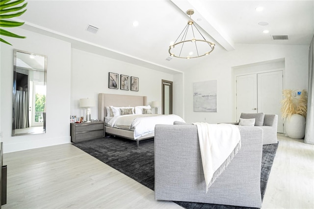 bedroom with hardwood / wood-style flooring, vaulted ceiling with beams, and a notable chandelier