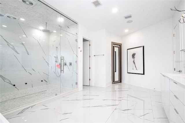 bathroom with vanity and a tile shower