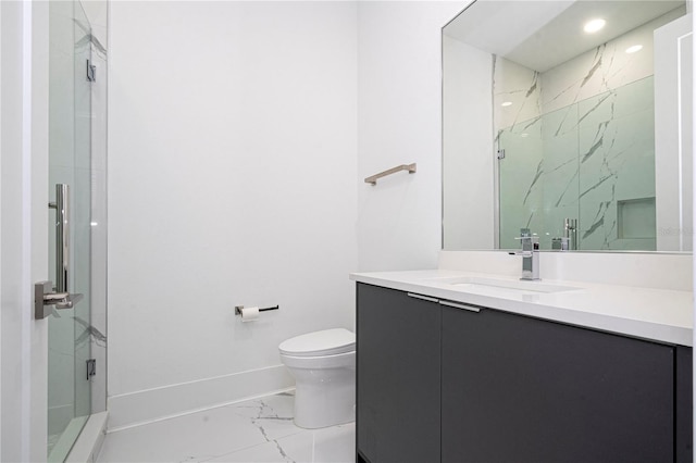 bathroom with vanity, an enclosed shower, and toilet