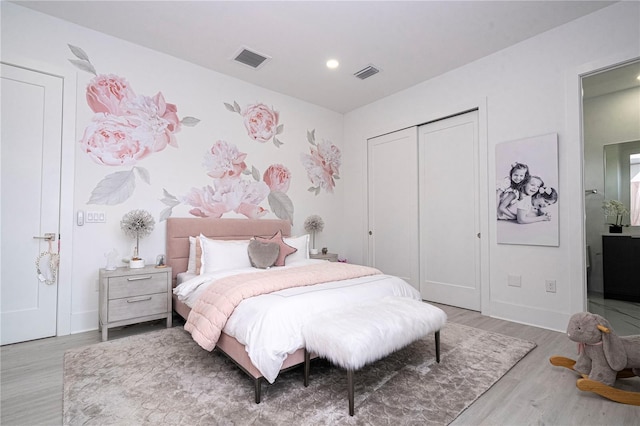 bedroom with light hardwood / wood-style flooring and a closet