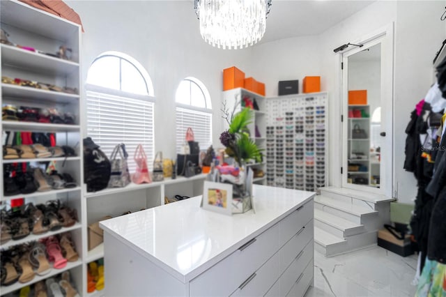 spacious closet with an inviting chandelier