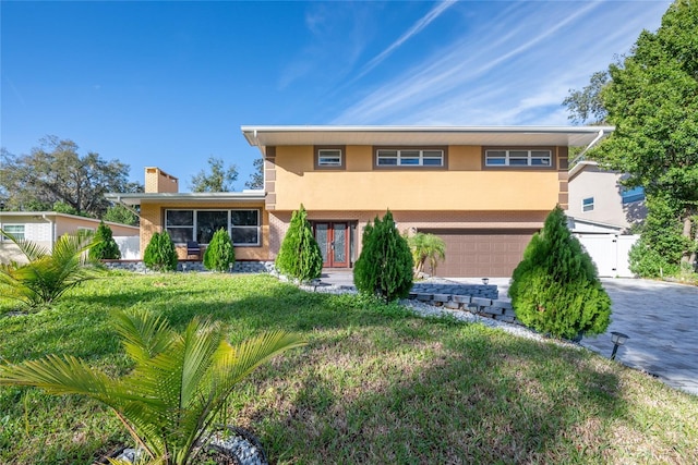 5006 Monet Ave, Belle Isle, FL 32812 - view of front facade with a garage and a front yard