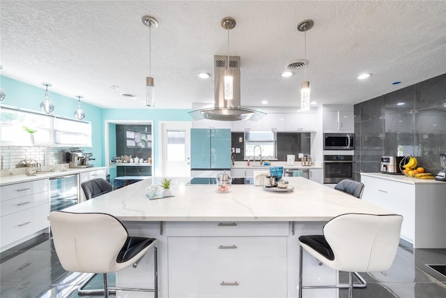 5006 Monet Ave, Belle Isle, FL 32812 - kitchen with a spacious island, pendant lighting, stainless steel appliances, and white cabinets