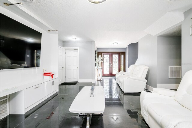 5006 Monet Ave, Belle Isle, FL 32812 - living room featuring french doors and a textured ceiling