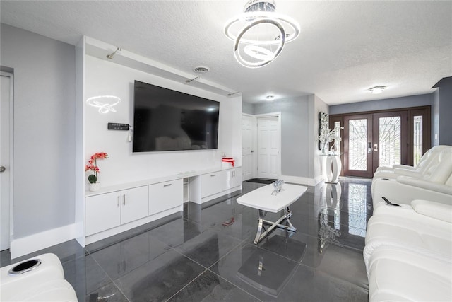 5006 Monet Ave, Belle Isle, FL 32812 - living room featuring french doors and a textured ceiling
