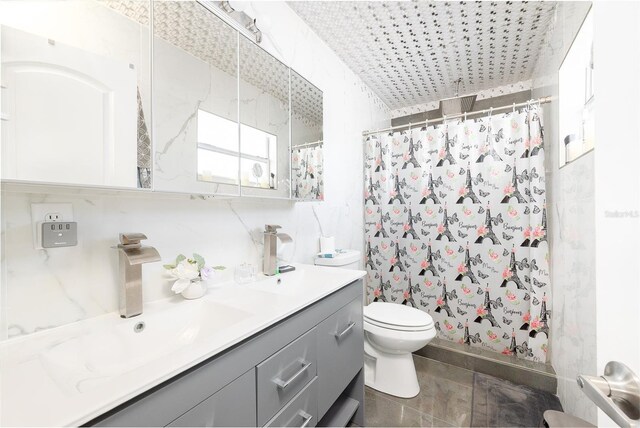 5006 Monet Ave, Belle Isle, FL 32812 - bathroom featuring vanity, toilet, a shower with shower curtain, and tile walls