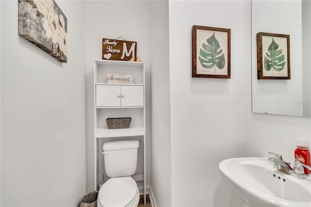 bathroom featuring sink and toilet