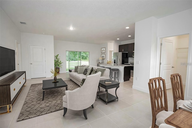 tiled living room with a textured ceiling