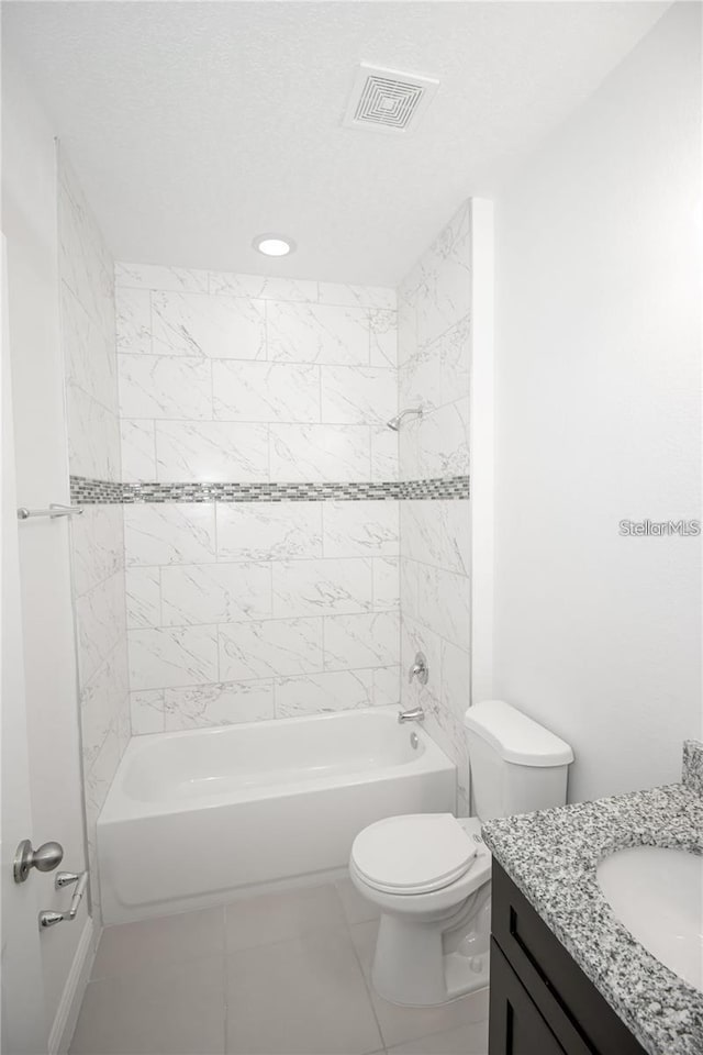 full bathroom featuring tiled shower / bath combo, vanity, and toilet