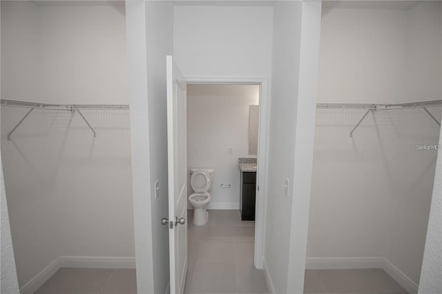 walk in closet featuring light tile patterned floors