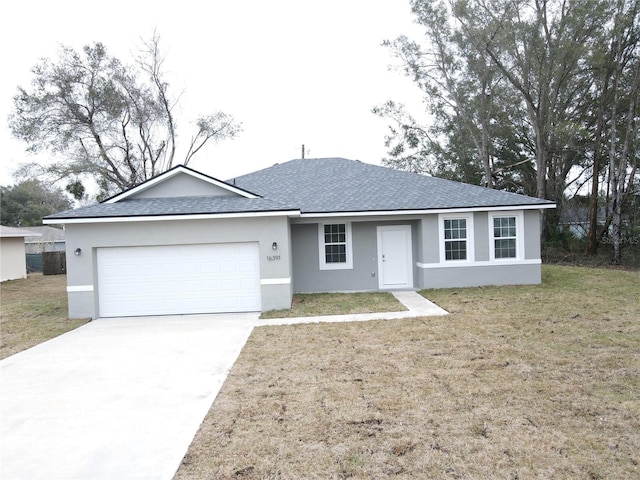 ranch-style home featuring a garage and a front yard