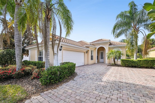 mediterranean / spanish home featuring a garage