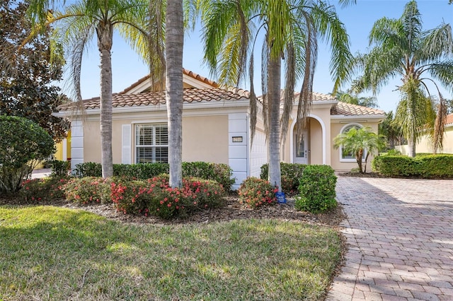 mediterranean / spanish house with a garage