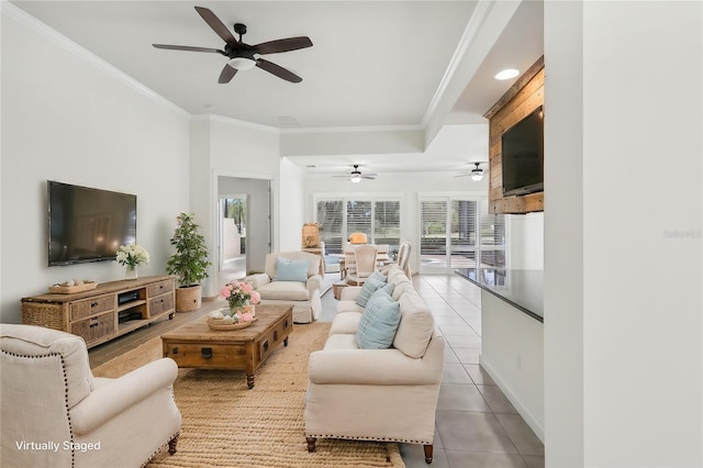 living room with light tile patterned floors, a wealth of natural light, and ornamental molding