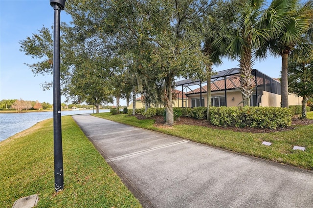 surrounding community featuring a water view and a lawn